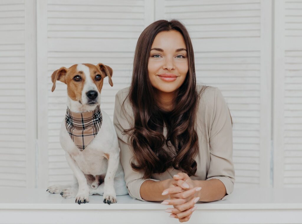 Woman spends leisure time with dog, loves animals, have friendly relationship with pet